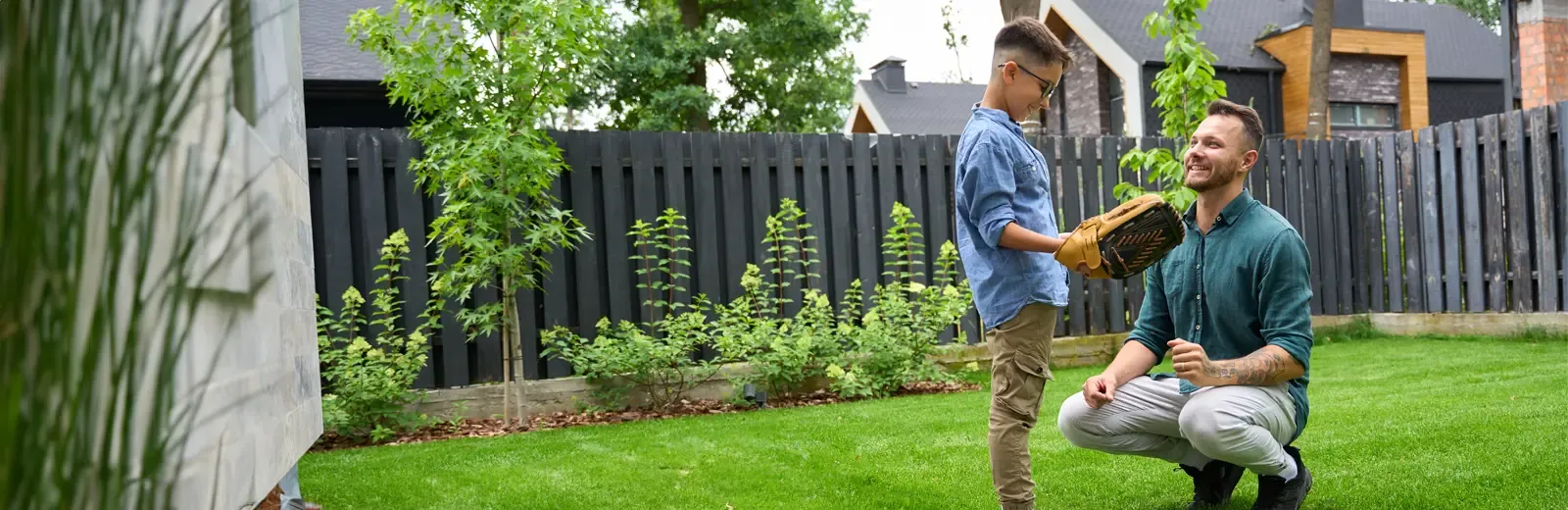 father and son playing catch in back yard