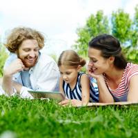 family reading on their lawn